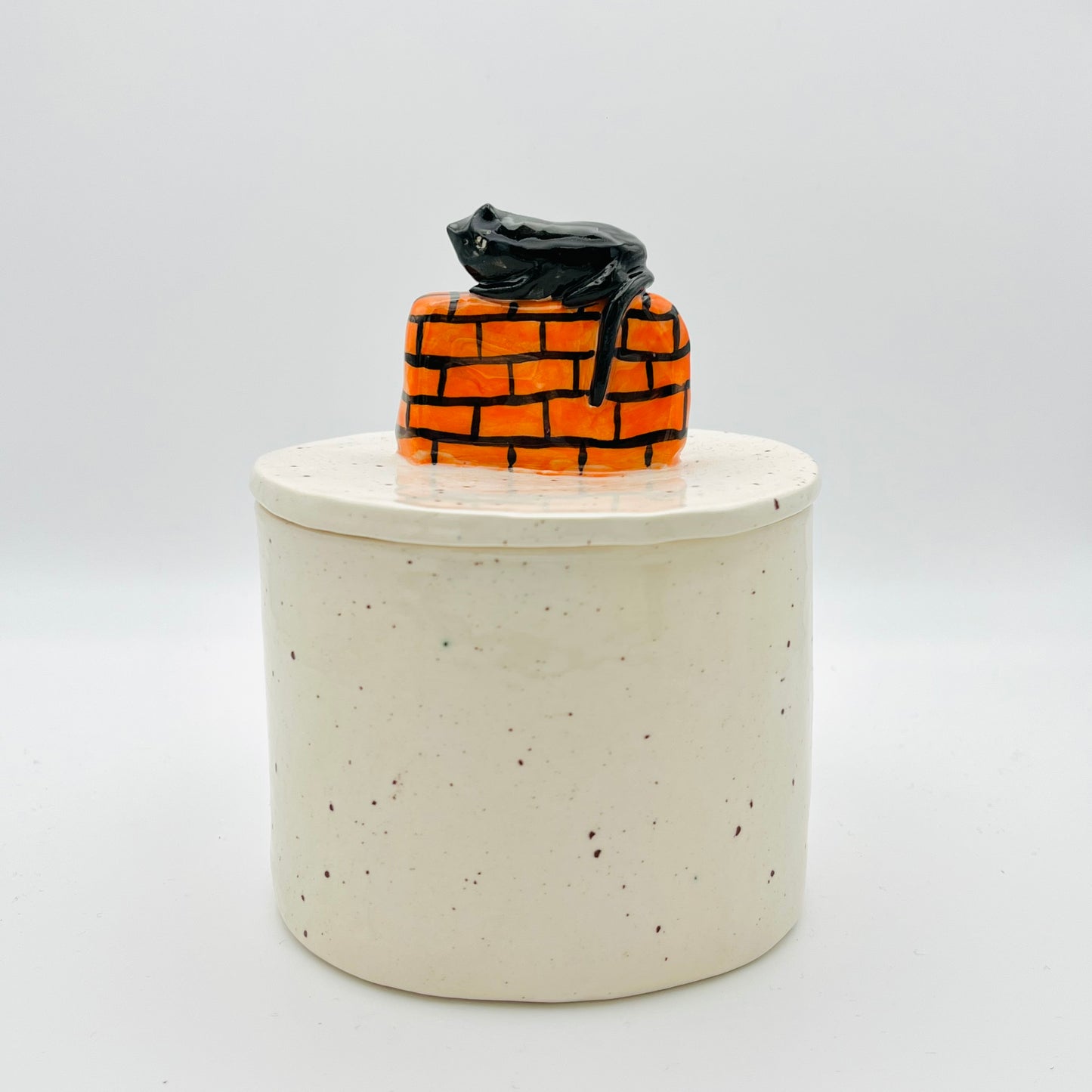 Cat on a wall lidded pot