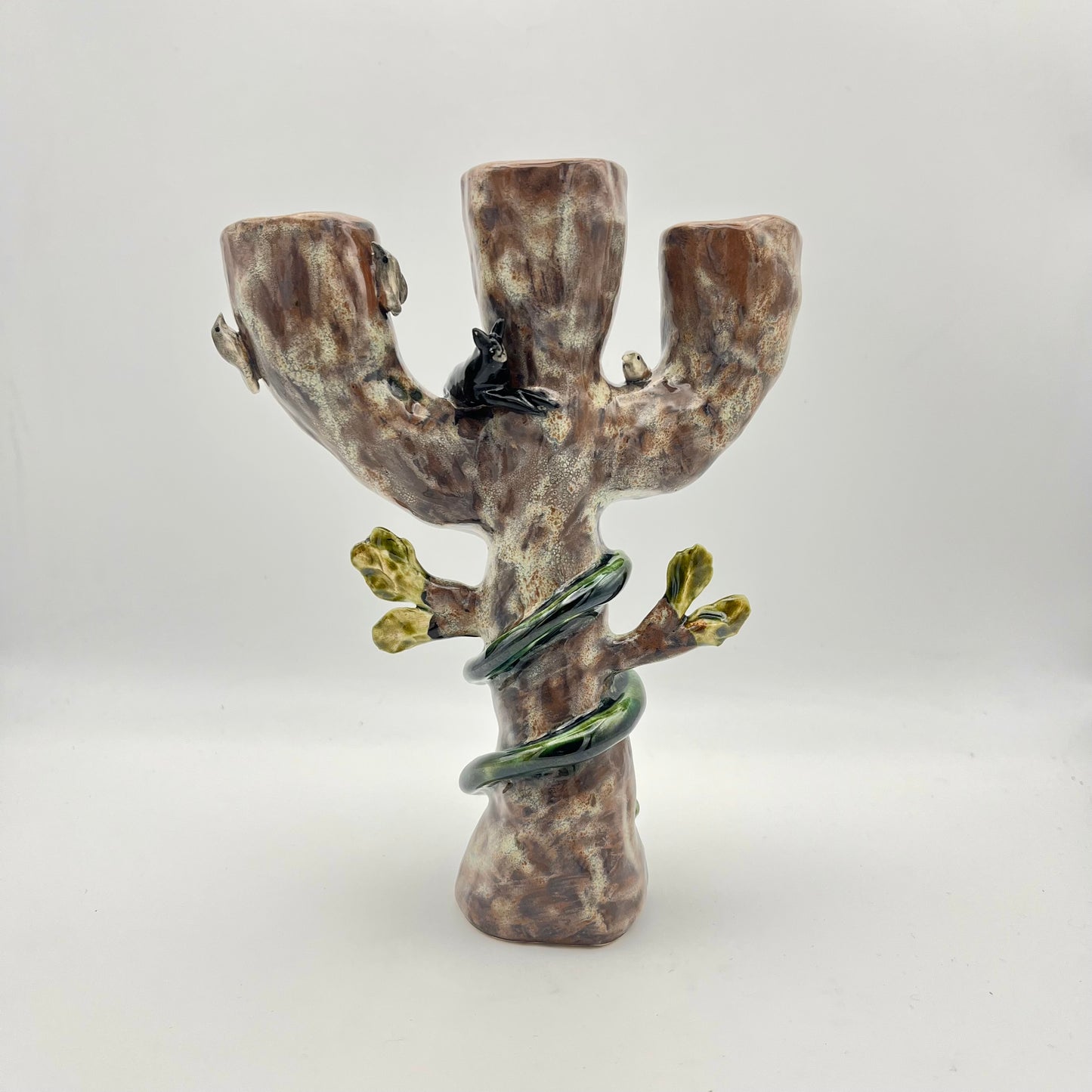 The cat, snake and bird candle holder