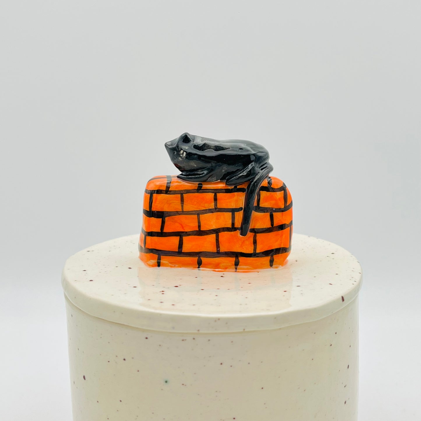 Cat on a wall lidded pot