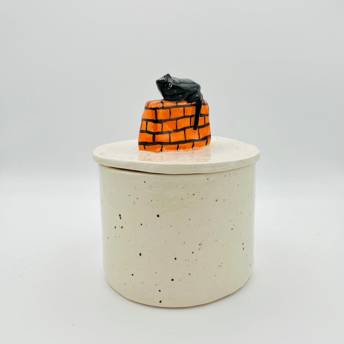 Cat on a wall lidded pot