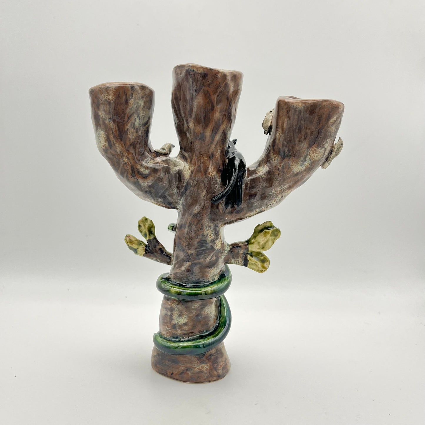 The cat, snake and bird candle holder